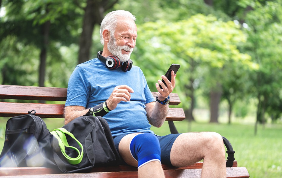 Man using phone on bench